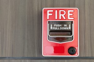 Push button switch fire and telephone on wood background